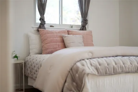 a bedroom with a bed and a window