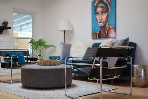 a living room with furniture and a potted plant