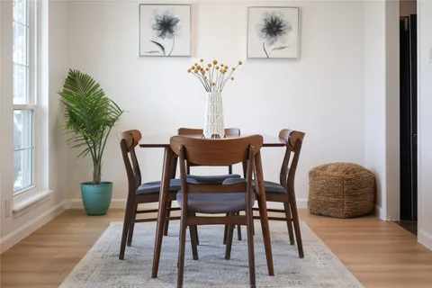 a view of a dining room with furniture and wooden floor