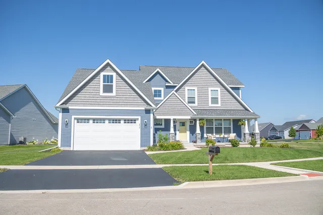 a front view of a house with a yard table and chairs