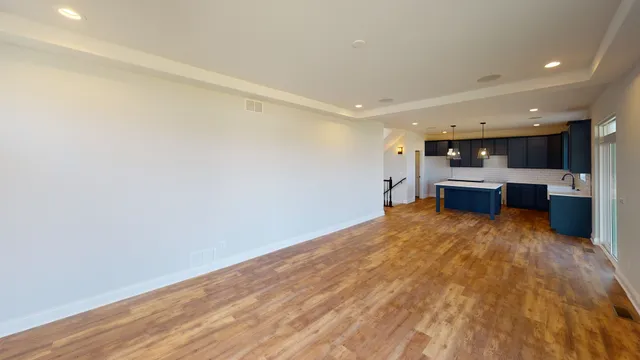 a view of a kitchen with a sink and a refrigerator