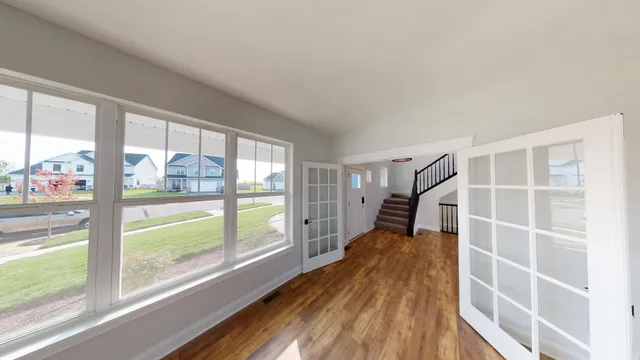 a view of wooden floor and windows in a room