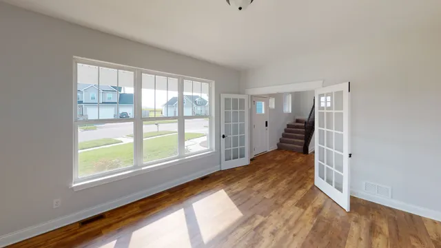 a view of an entryway with wooden floor and windows