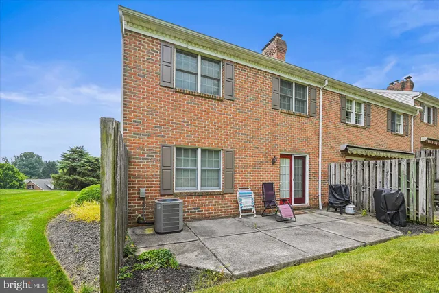 a view of a house with backyard porch and wooden fence