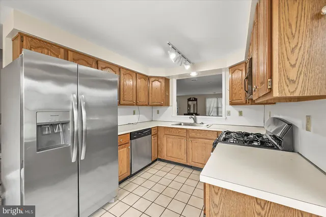 a kitchen with stainless steel appliances granite countertop a sink and cabinets