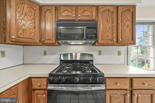 a stove top oven sitting inside of a kitchen