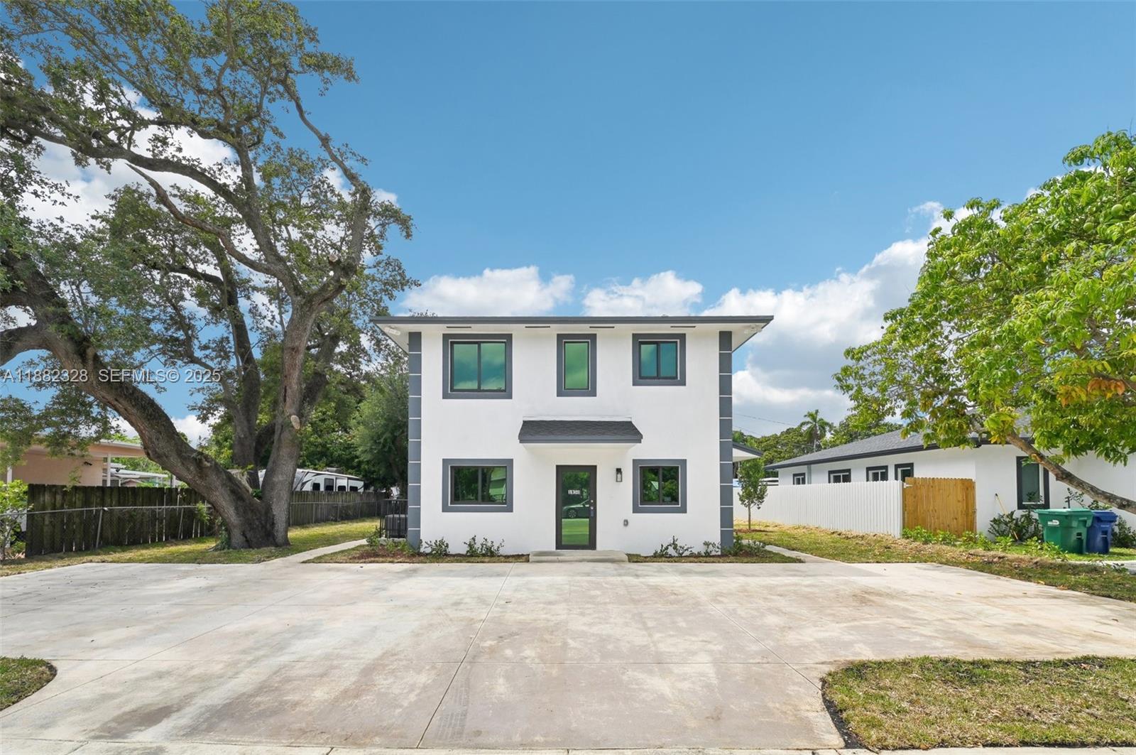 10344 Northwest 29th Avenue, Unit 10344 Miami, FL 33147 - Photo 2 of 12 a front view of a house with a yard and garage