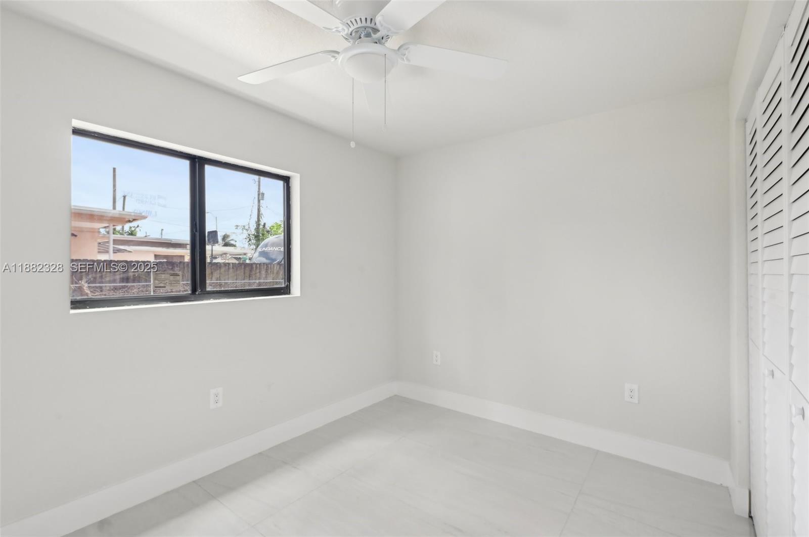 10344 Northwest 29th Avenue, Unit 10344 Miami, FL 33147 - Photo 6 of 12 a view of an empty room with a window
