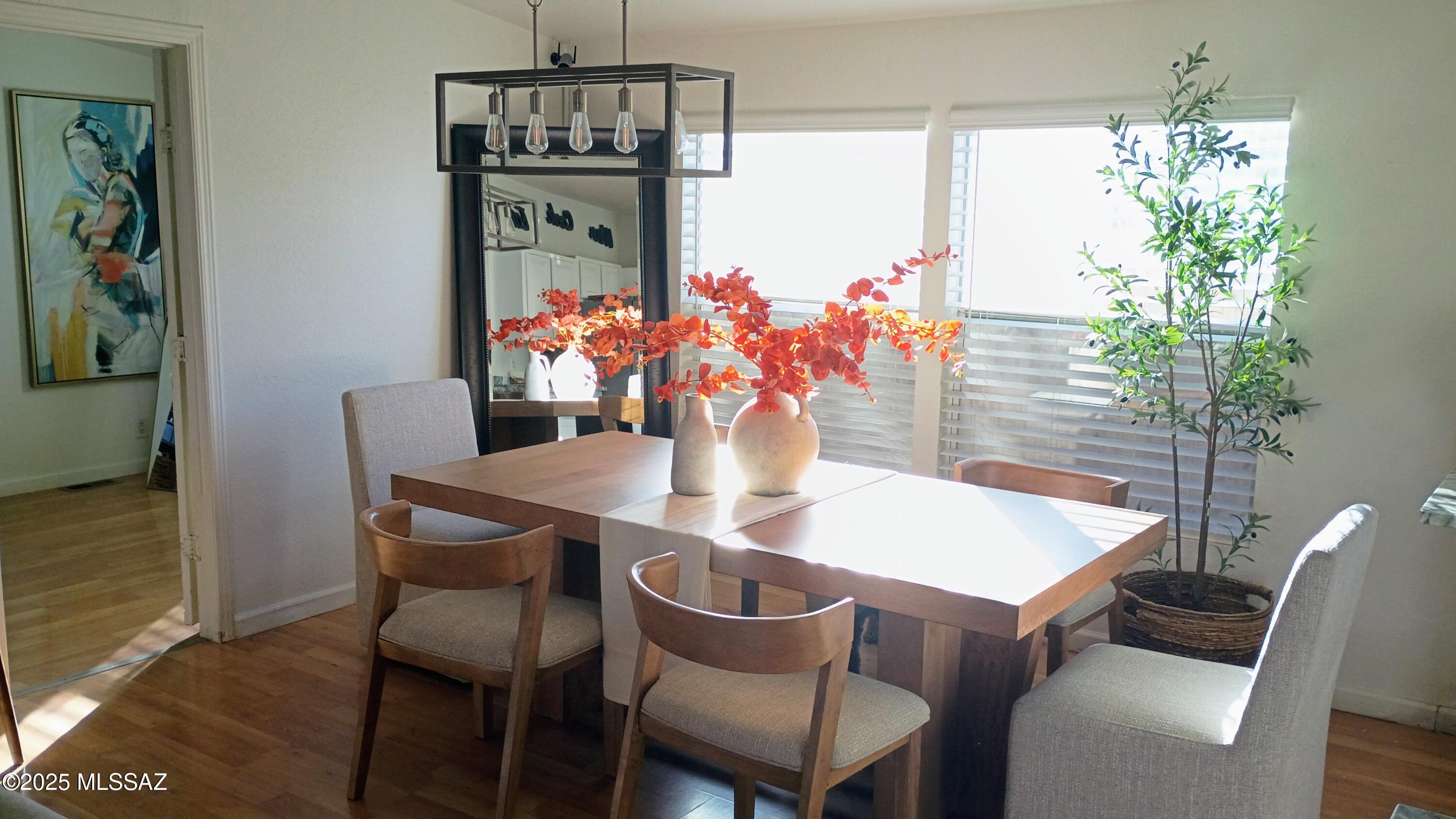 1449 West Hualpai Road Tucson, AZ 85745 - Photo 11 of 49 a dining room with furniture potted plants and wooden floor