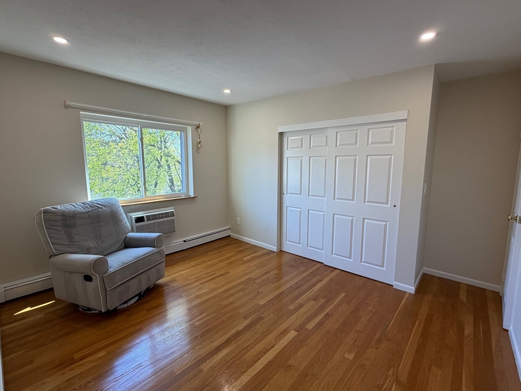 383 Langley Road, Unit 11 Newton, MA 02459 - Photo 10 of 15 a living room with furniture and wooden floor