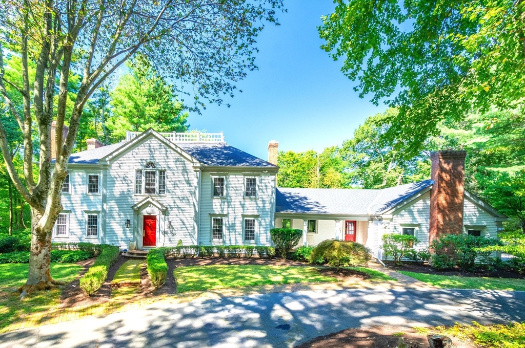 138 Pine Street Dover, MA 02030 - Photo 1 of 38 a front view of a house with a yard and potted plants