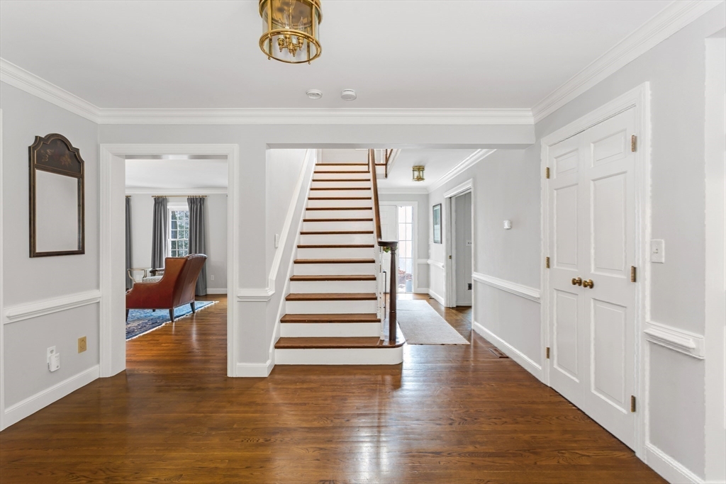 138 Pine Street Dover, MA 02030 - Photo 16 of 38 a view of a hallway with wooden floor and staircase