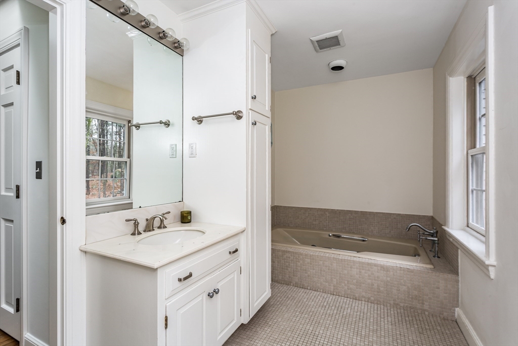 138 Pine Street Dover, MA 02030 - Photo 23 of 38 a bathroom with a tub sink and mirror