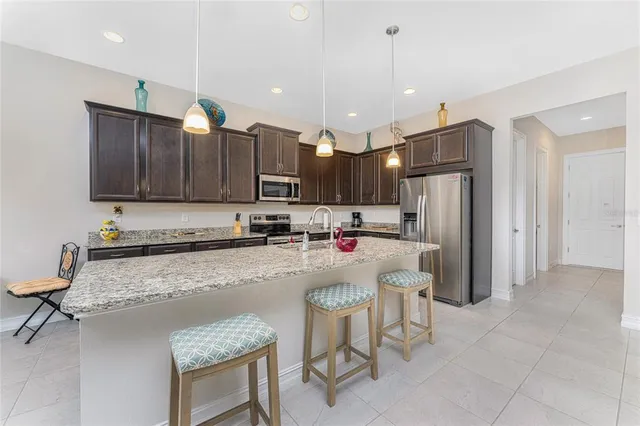 a living room with furniture a flat screen tv and a table