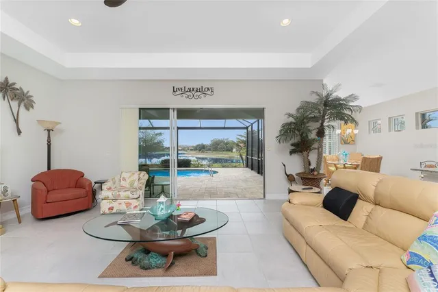 a living room with furniture and a mirror