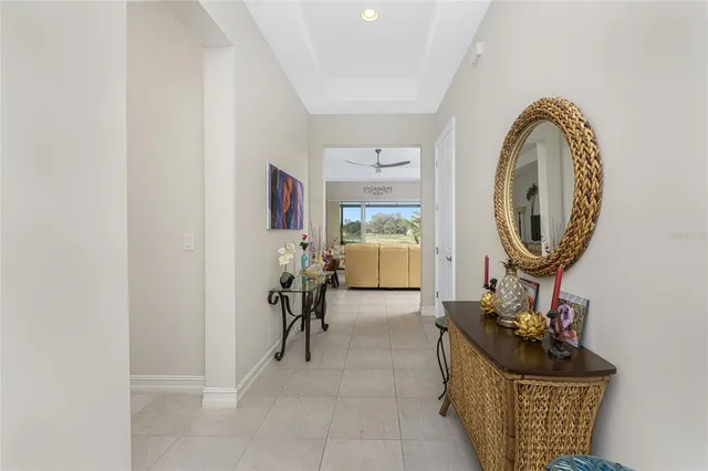 a kitchen with stainless steel appliances granite countertop a stove top oven a sink refrigerator and chairs