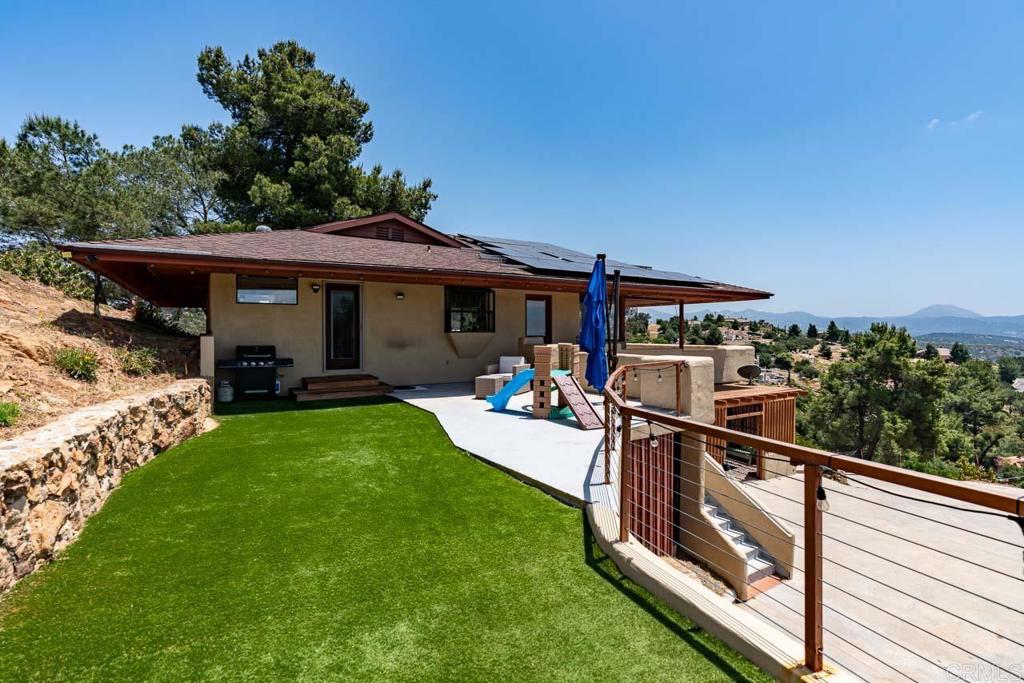 a view of a porch with furniture and garden