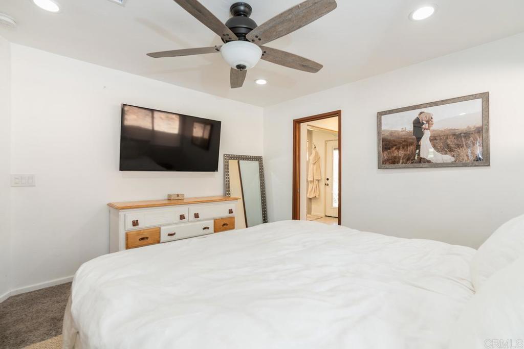315 Alpine Heights Road Alpine, CA 91901 - Photo 16 of 42 a bedroom with a bed and a flat tv screen on dresser