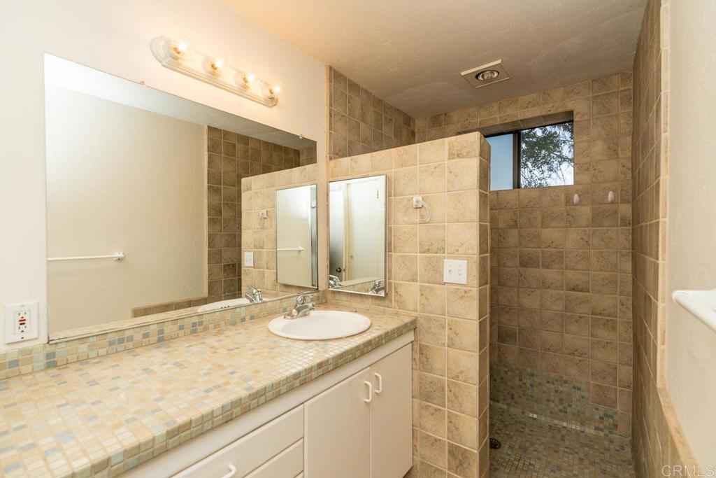 315 Alpine Heights Road Alpine, CA 91901 - Photo 28 of 42 a bathroom with a granite countertop sink and a mirror