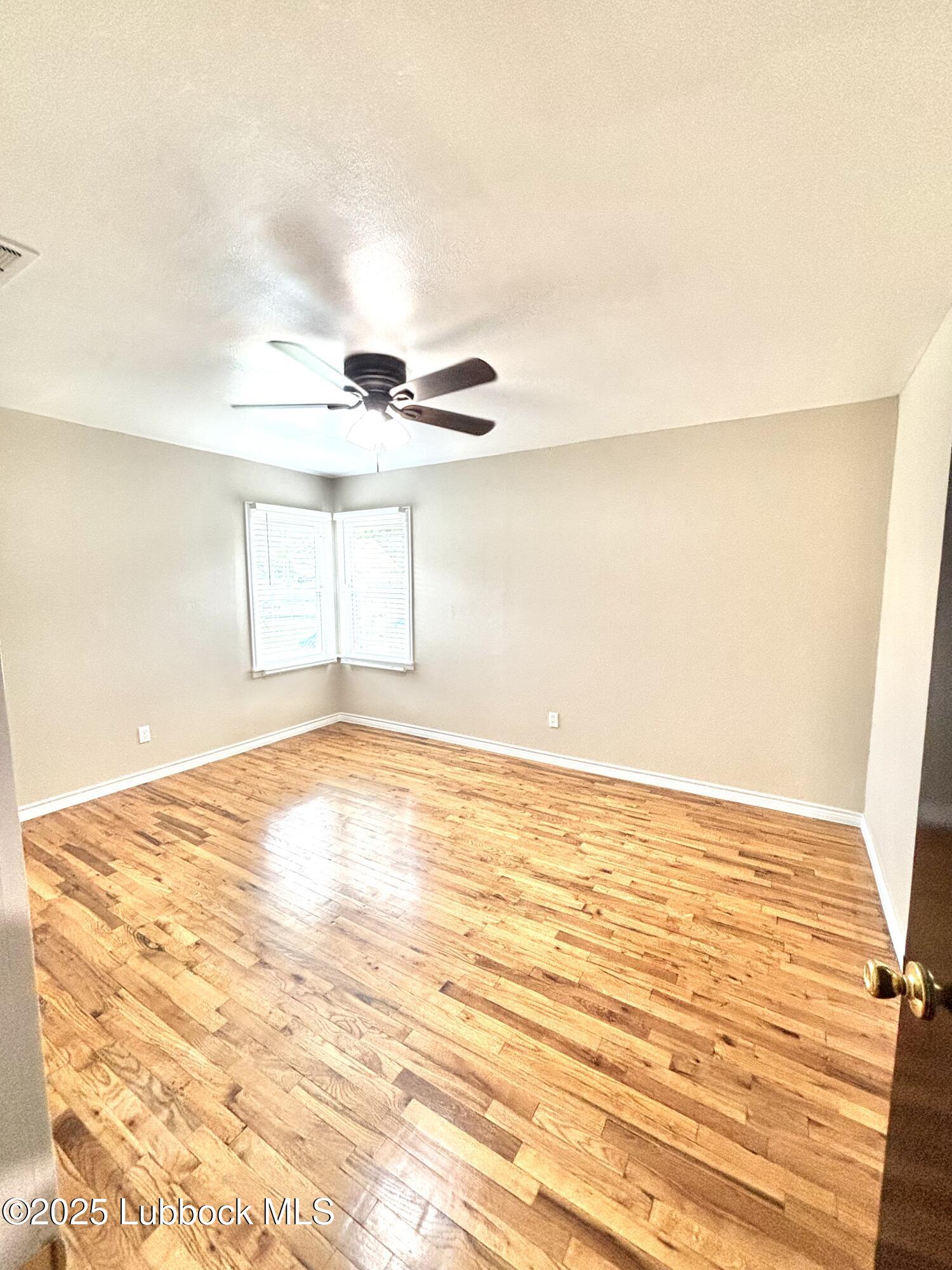 815 Amarillo Plainview, TX 79072 - Photo 11 of 17 a view of empty room with wooden floor