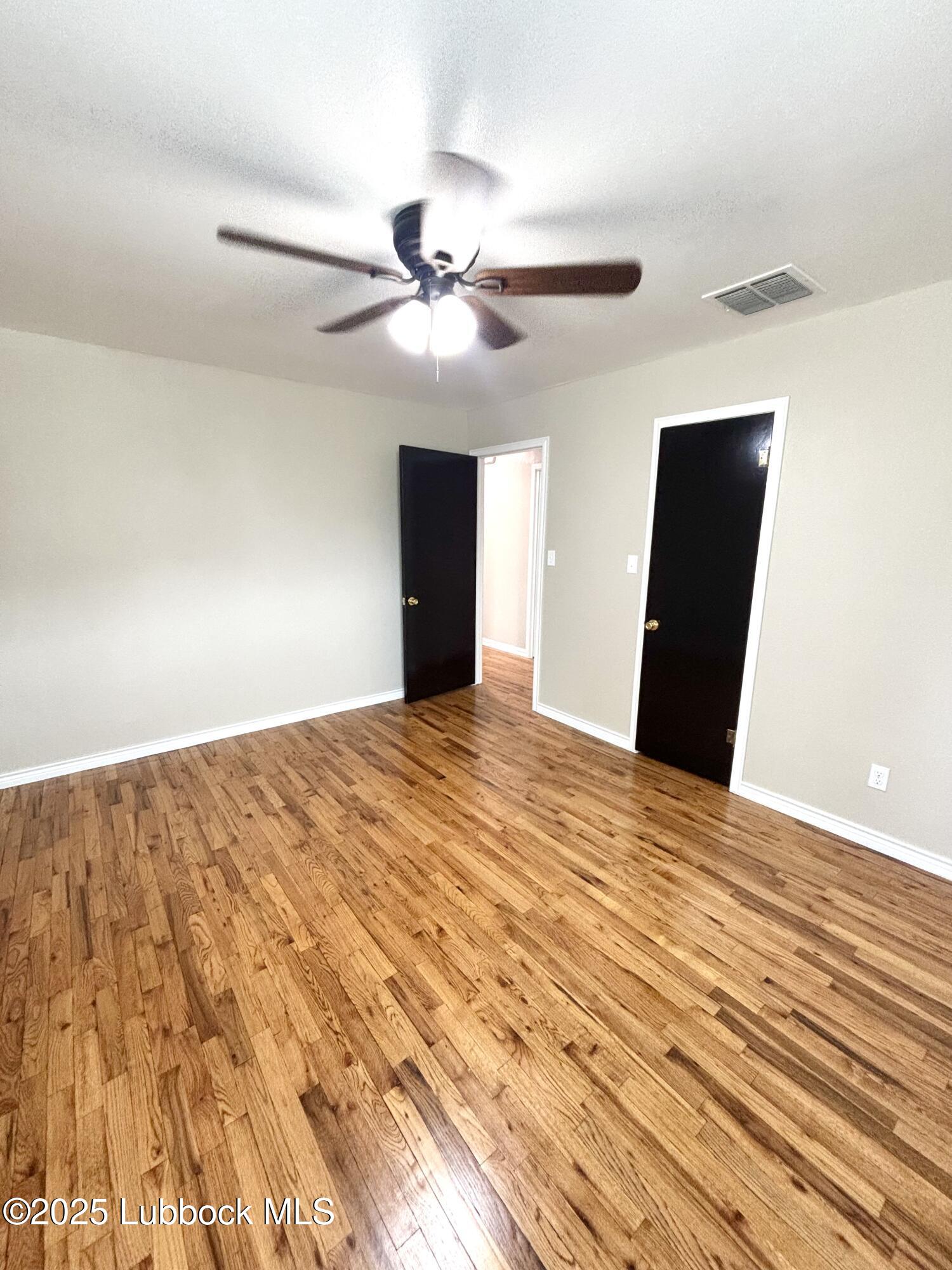 815 Amarillo Plainview, TX 79072 - Photo 12 of 17 a view of empty room with wooden floor