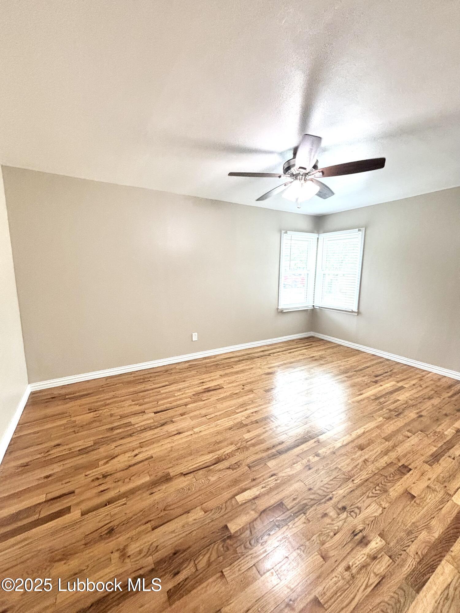 815 Amarillo Plainview, TX 79072 - Photo 13 of 17 wooden floor in an empty room