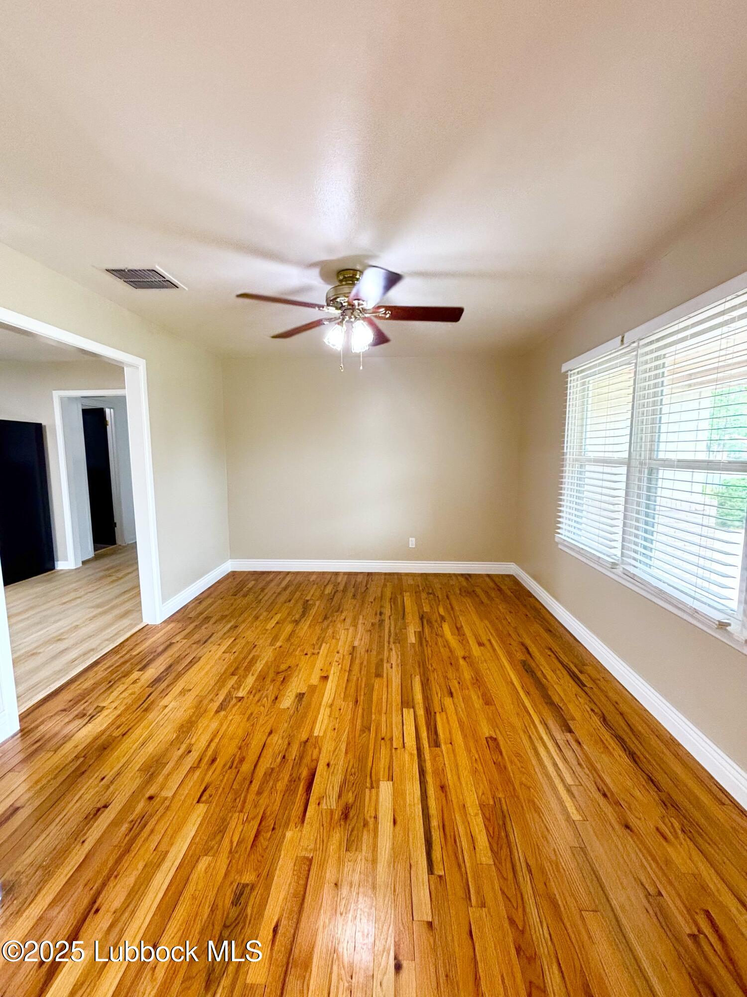 815 Amarillo Plainview, TX 79072 - Photo 3 of 17 a view of a room with wooden floor