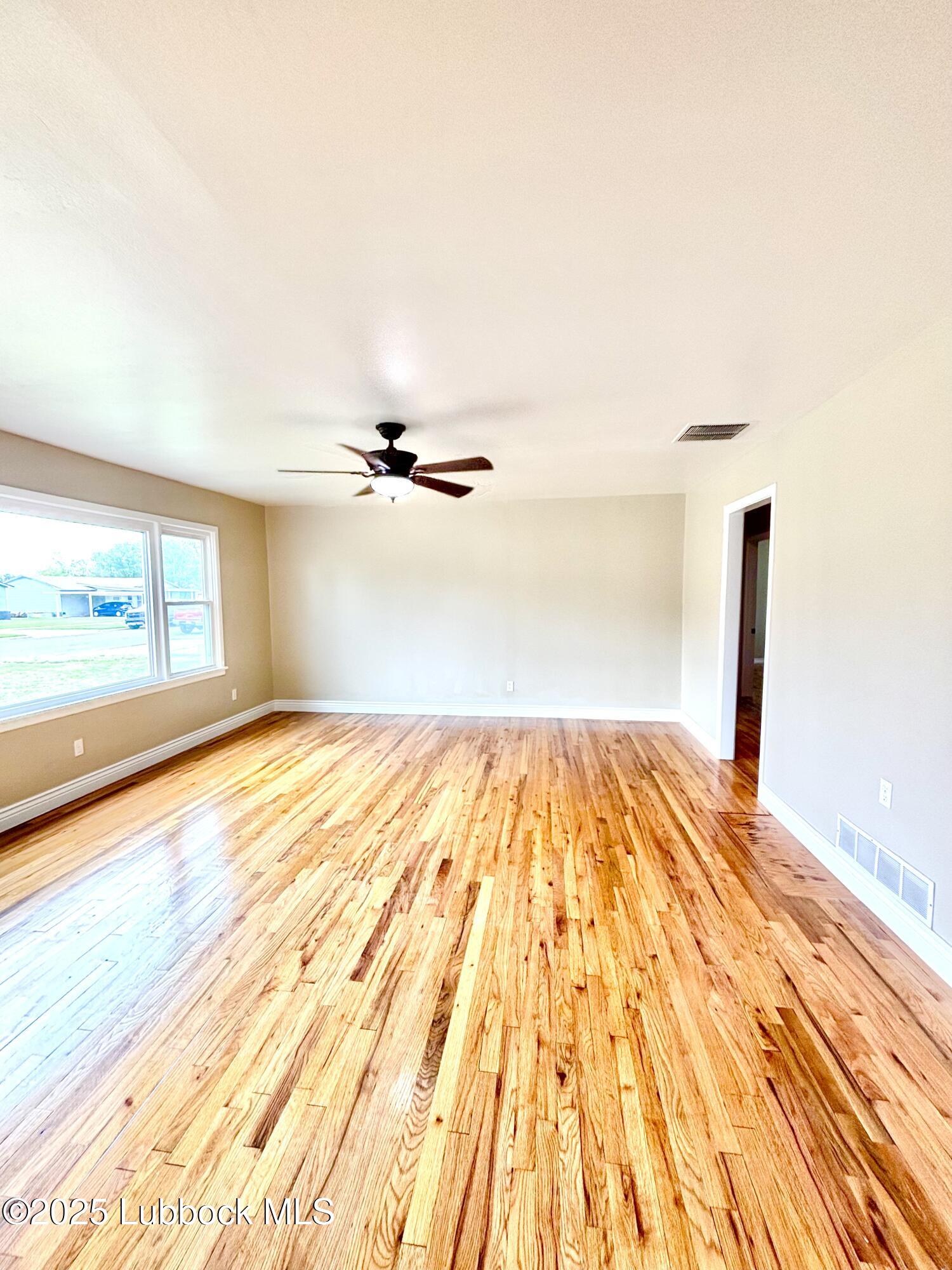 815 Amarillo Plainview, TX 79072 - Photo 6 of 17 a view of empty room with wooden floor