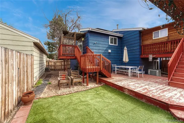 a view of backyard with wooden fence