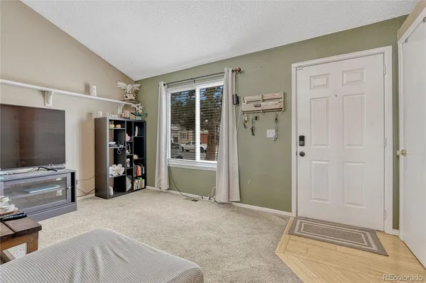 a view of a livingroom with entryway and furniture