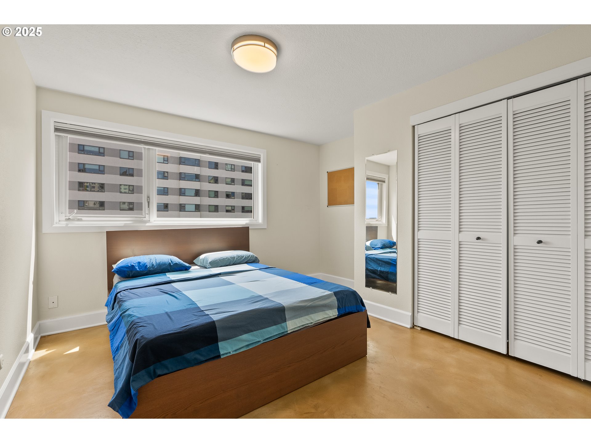 2211 Southwest Park Place, Unit 903 Portland, OR 97205 - Photo 18 of 34 a bedroom with a bed and a table