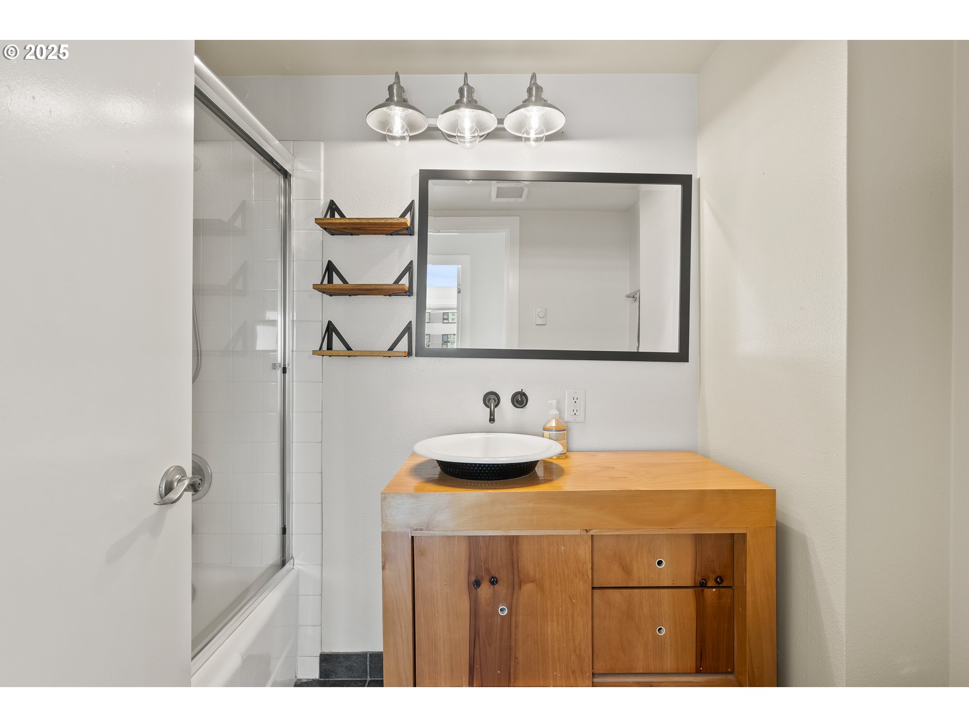 2211 Southwest Park Place, Unit 903 Portland, OR 97205 - Photo 20 of 34 a bathroom with a sink and a mirror