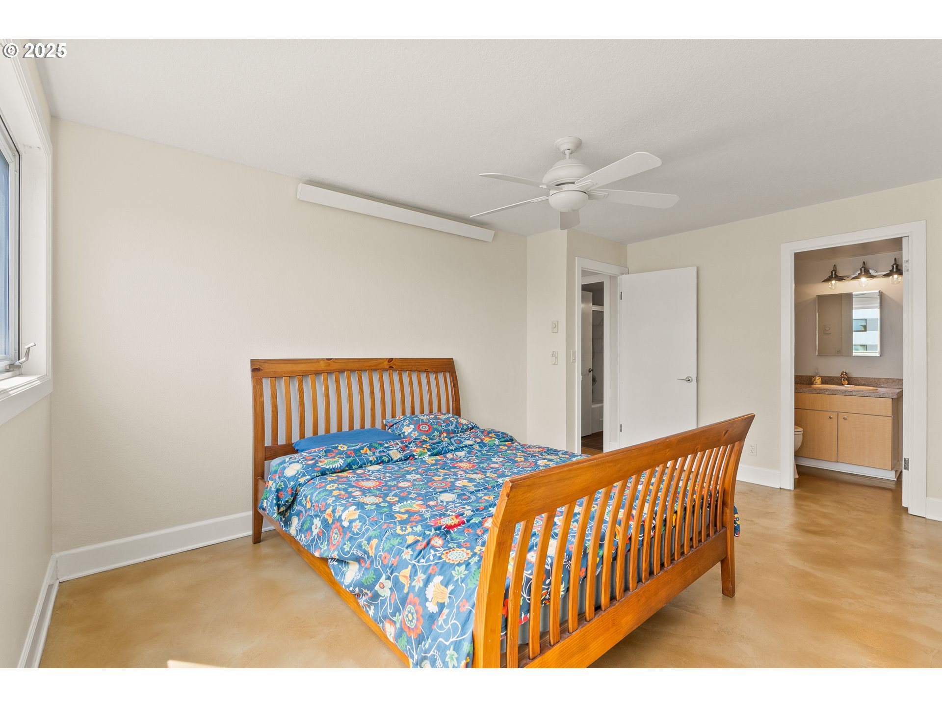 2211 Southwest Park Place, Unit 903 Portland, OR 97205 - Photo 21 of 34 a bedroom with a bed and a chandelier