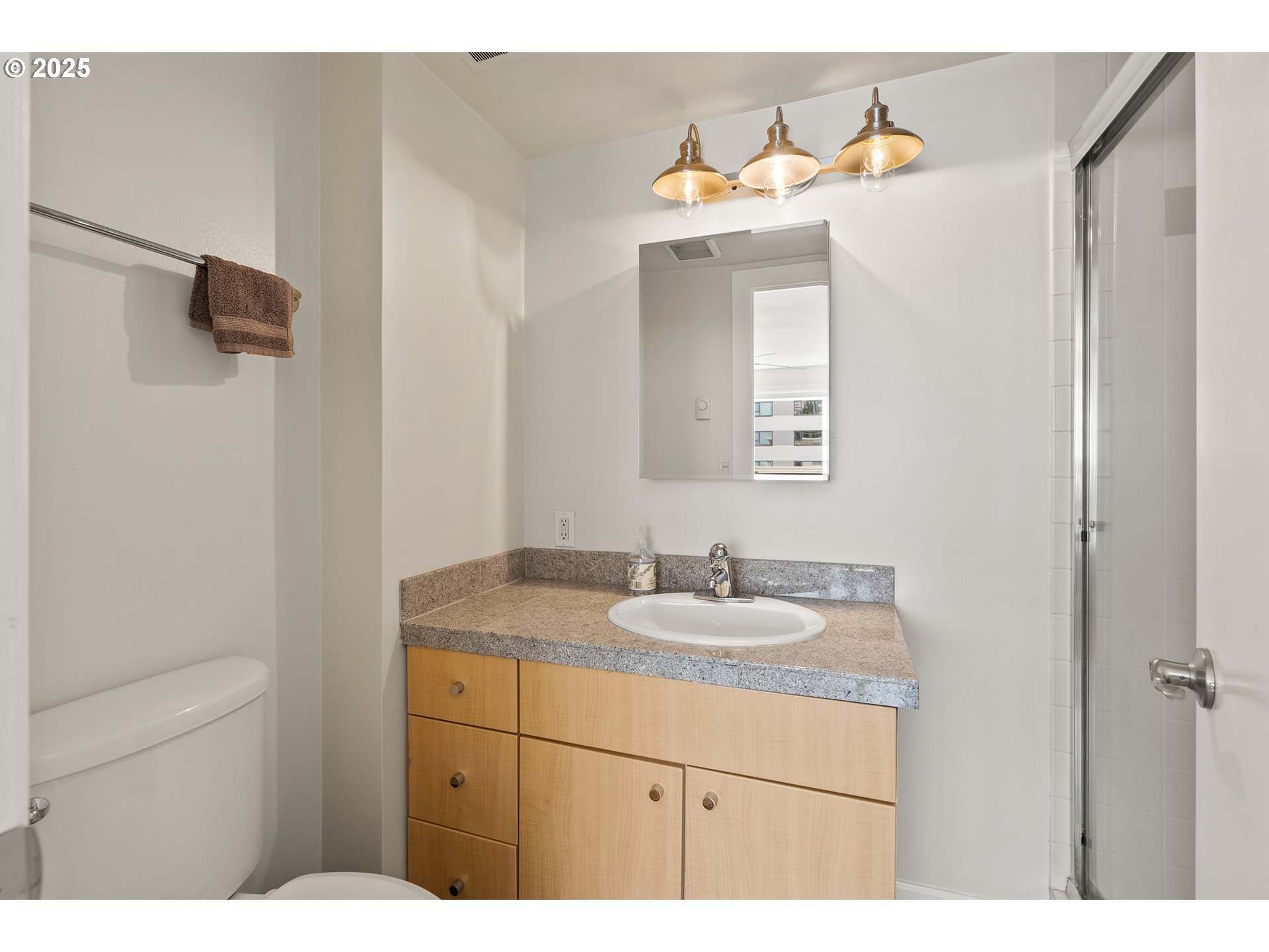 2211 Southwest Park Place, Unit 903 Portland, OR 97205 - Photo 23 of 34 a bathroom with a sink and a mirror