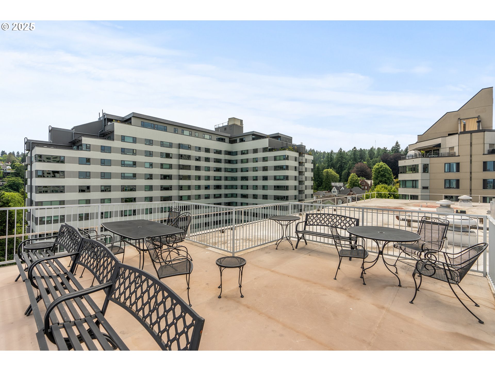 2211 Southwest Park Place, Unit 903 Portland, OR 97205 - Photo 27 of 34 a view of a patio with a table and chairs and potted plants
