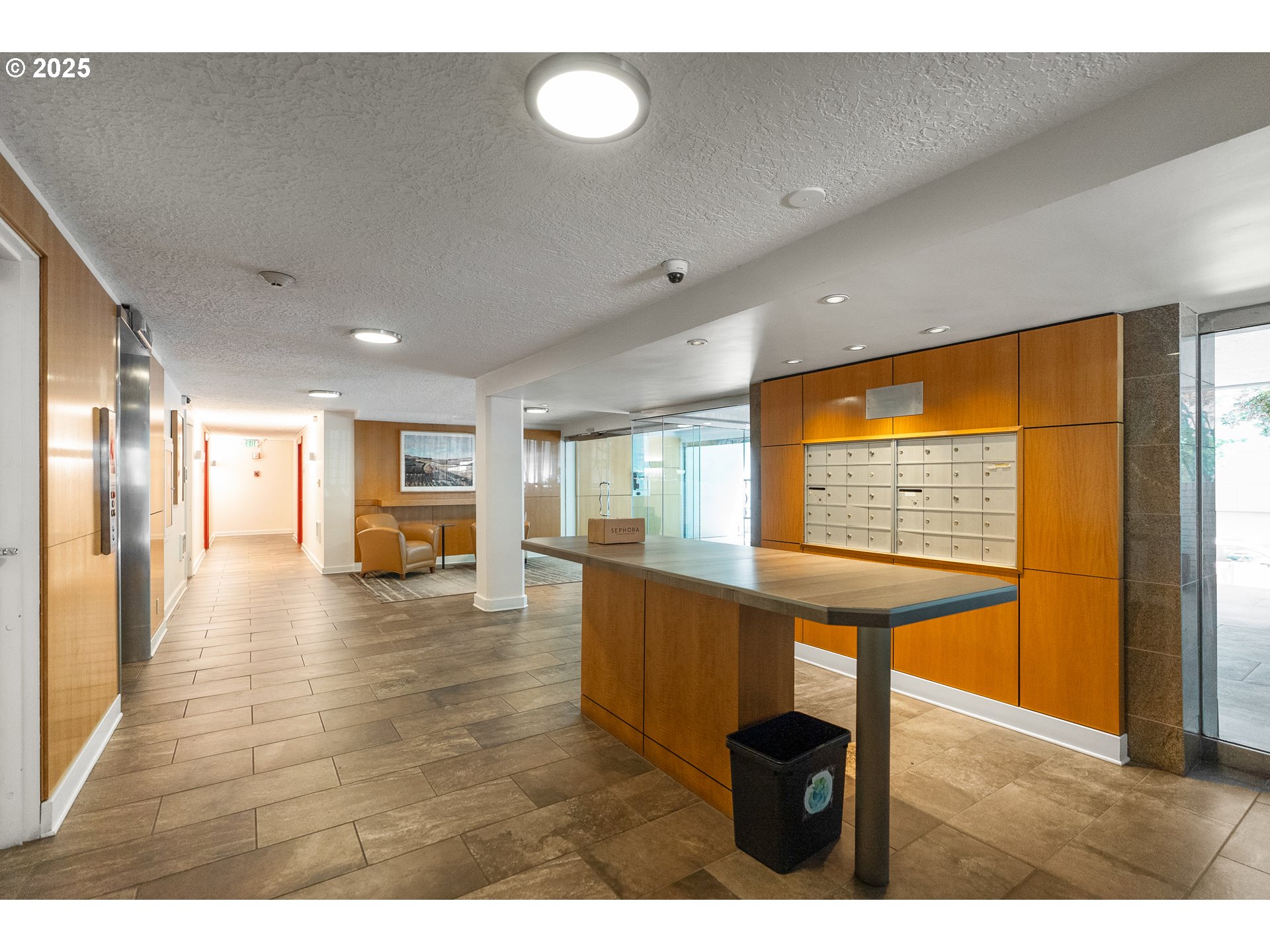 2211 Southwest Park Place, Unit 903 Portland, OR 97205 - Photo 5 of 34 a view of open kitchen with a table and chairs