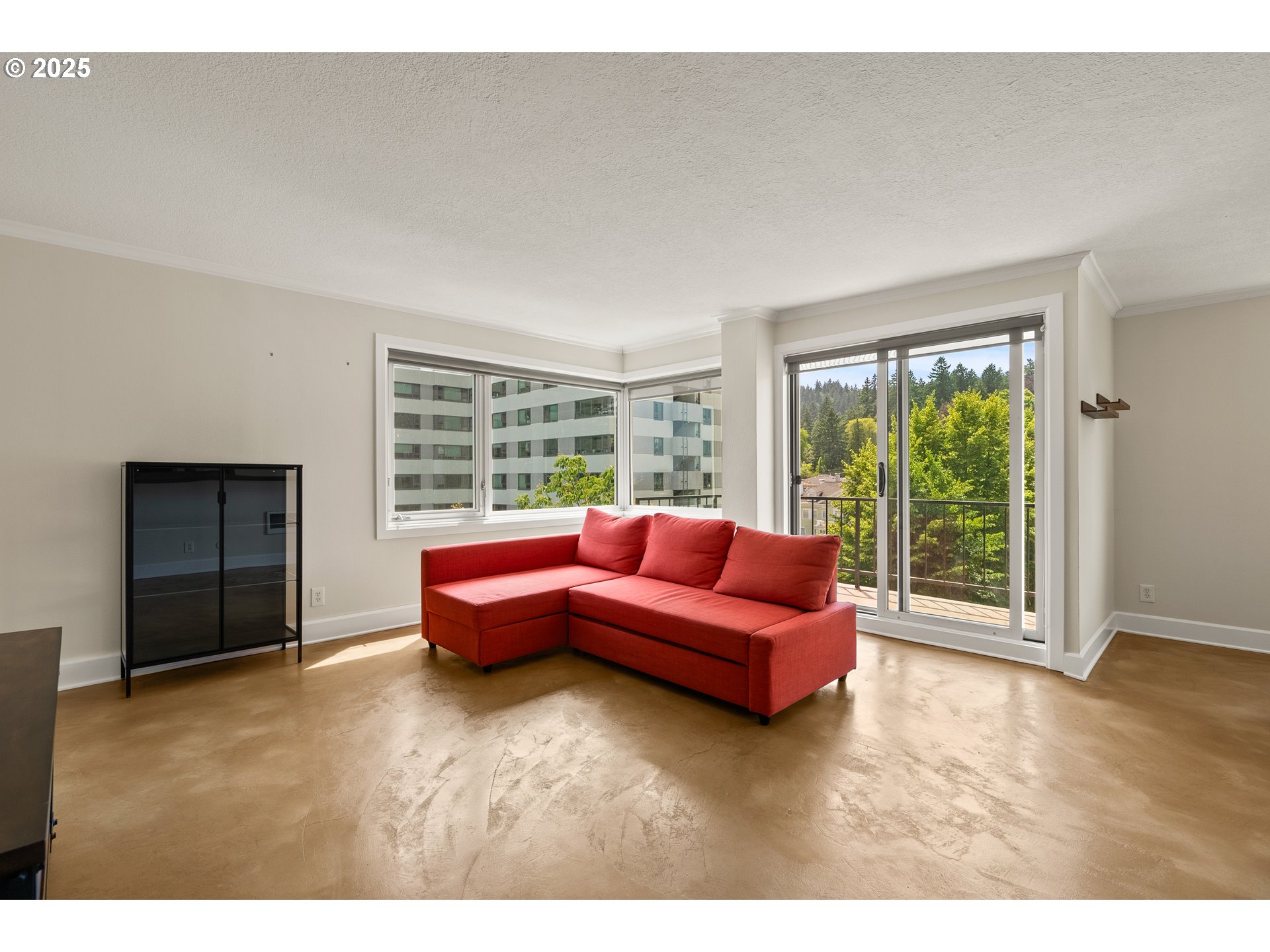 2211 Southwest Park Place, Unit 903 Portland, OR 97205 - Photo 7 of 34 a living room with furniture and a large window