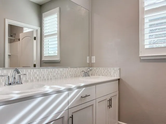 a bathroom with a sink a bathtub and window