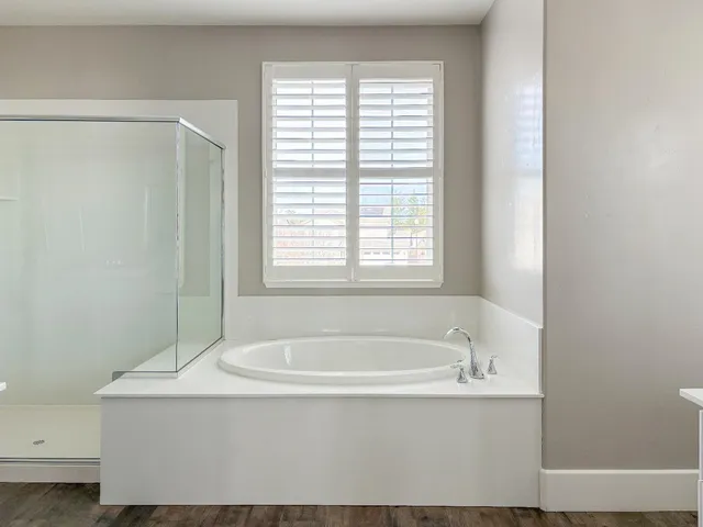 an empty room with an entryway and a window