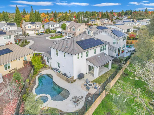 an aerial view of residential houses with outdoor space
