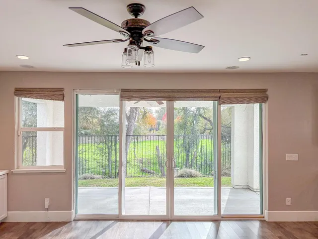 a view of a livingroom with a ceiling fan and window