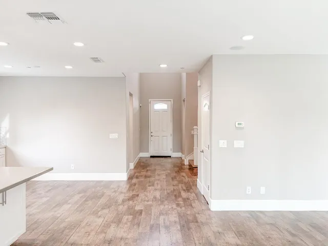 a large kitchen with cabinets and wooden floor