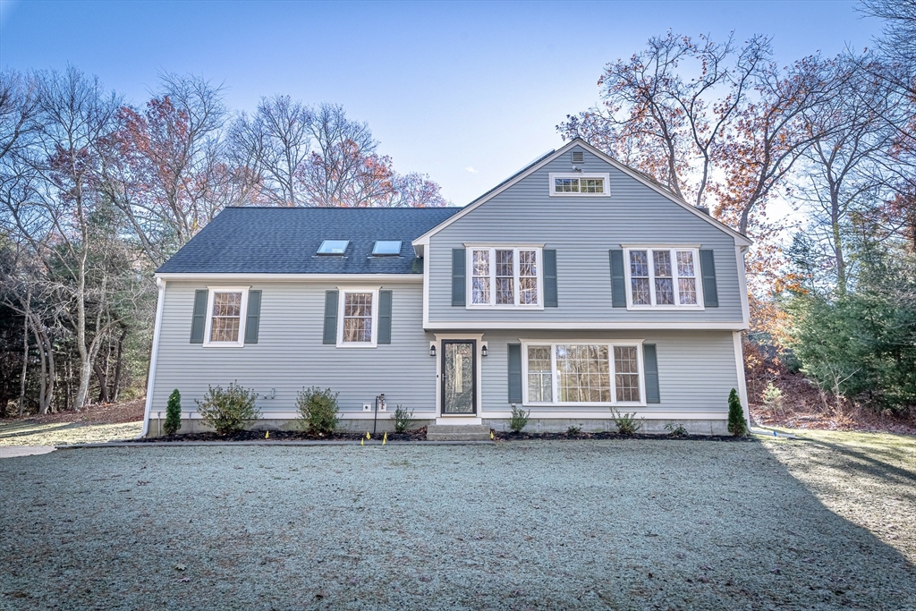a front view of a house with a yard