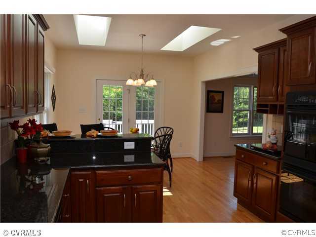 3707 Bailey Farm Road Moseley, VA 23120 - Photo 4 of 12 a view of dining room and kitchen with a table chairs a workspace