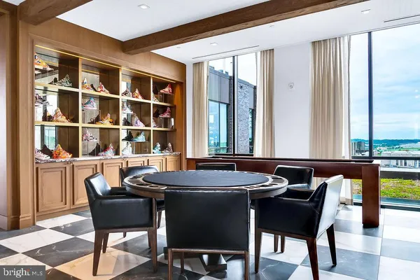 a dining room with furniture a rug and a large window