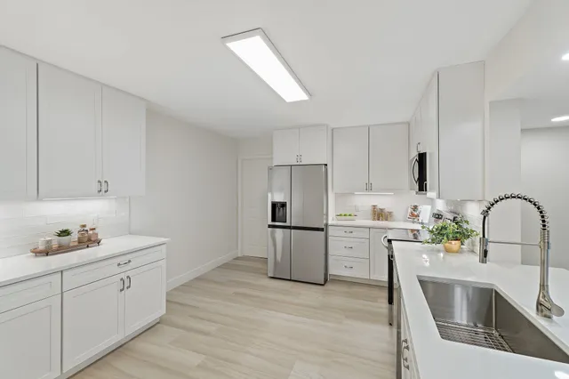 a view of lot of kitchen with furniture and wooden floor