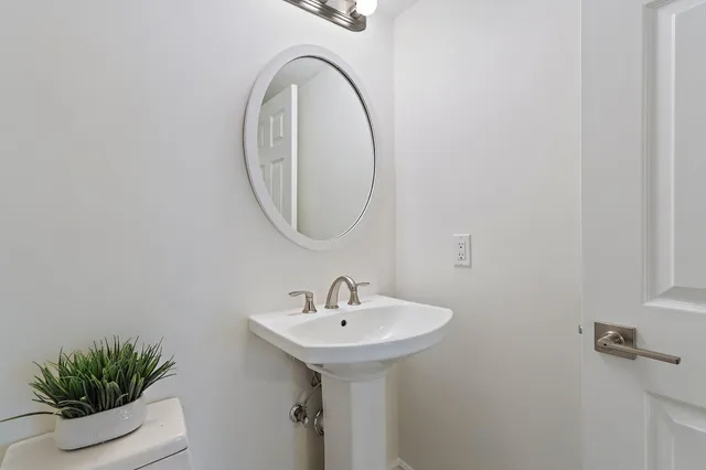 a bathroom with a granite countertop sink a toilet and shower