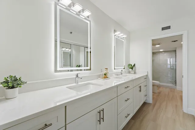 a bedroom with a bed and painting on the wall