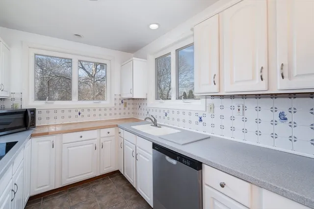 a kitchen with sink cabinets and window