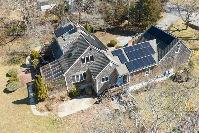 a view of a house with a yard covered in snow